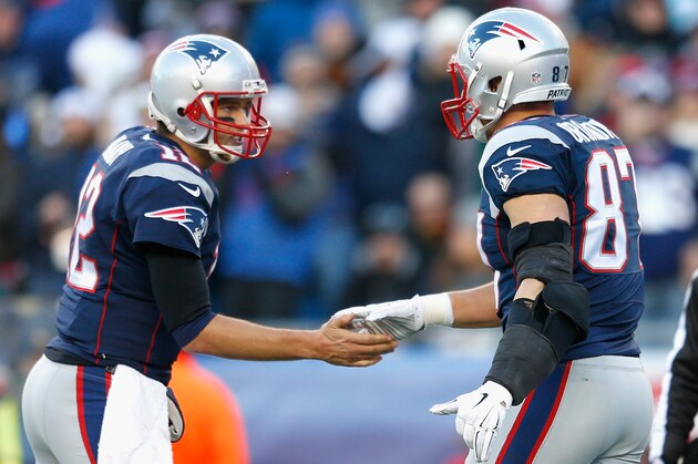 FOXBORO, MA - DECEMBER 14:  Tom Brady #12 and Rob Gronkowski #87 of the New England Patriots react after Gronkowski caught a touchdown pass during the third quarter against the Miami Dolphins at Gillette Stadium on December 14, 2014 in Foxboro, Massachusetts.  (Photo by Jim Rogash/Getty Images)