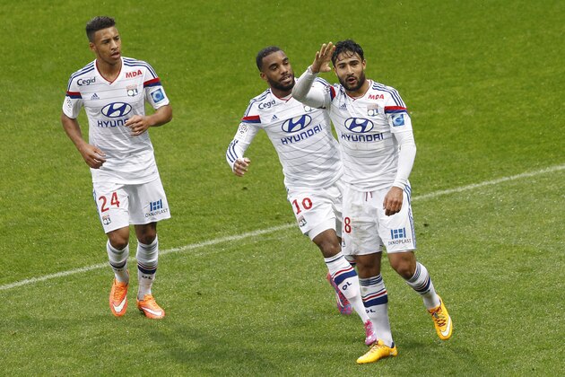 Lyon's Nabil Fekir, right, celebrates with Alexandre Lacazette, center, and Corentin Tolisso, left, after he scored a goal against Guingamp during their French League One soccer match in Lyon, central France, Sunday, Nov. 9, 2014. (AP Photo/Laurent Cipriani)