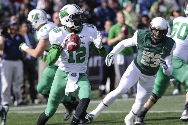 Marshall quarterback Rakeem Cato (12) is seen passing against UAB during an NCAA college football game, Saturday, Nov. 22, 2014, in Birmingham, Ala. (AP Photo/John Amis)
