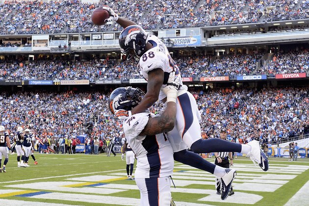 SAN DIEGO, CA - DECEMBER 14:  Wide receiver Demaryius Thomas #88 of the Denver Broncos celebrates with teammate guard Orlando Franklin #74 of the Denver Broncos after Thomas caught a 28-yard touchdown against the San Diego Chargers at Qualcomm Stadium on December 14, 2014 in San Diego, California.  (Photo by Harry How/Getty Images)