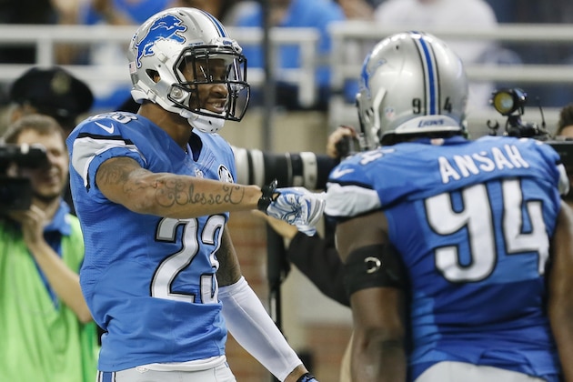 Detroit Lions cornerback Darius Slay (23) is greeted by teammate Ezekiel Ansah after an interception during the first half of an NFL football game against the Minnesota Vikings at Ford Field in Detroit, Sunday, Dec. 14, 2014. (AP Photo/Paul Sancya)