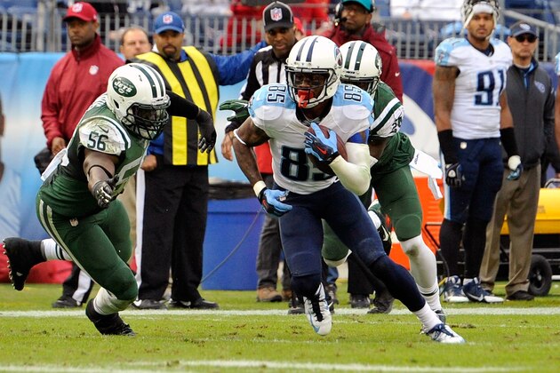 NASHVILLE, TN - DECEMBER 14: Wide receiver Nate Washington #85 of the Tennessee Titans carries the ball after a reception against Demario Davis #56 of the New York Jets in the second quarter of a game at LP Field on December 14, 2014 in Nashville, Tennessee. (Photo by Frederick Breedon/Getty Images)