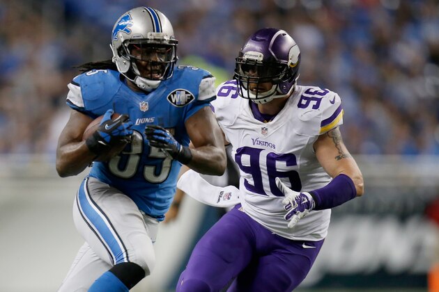 DETROIT, MI - DECEMBER 14: Joique Bell #35 of the Detroit Lions tries to outrun the tackle of Brian Robison #96 of the Minnesota Vikings during the third quarter at Ford Field on December 14, 2014 in Detroit, Michigan. (Photo by Gregory Shamus/Getty Images)