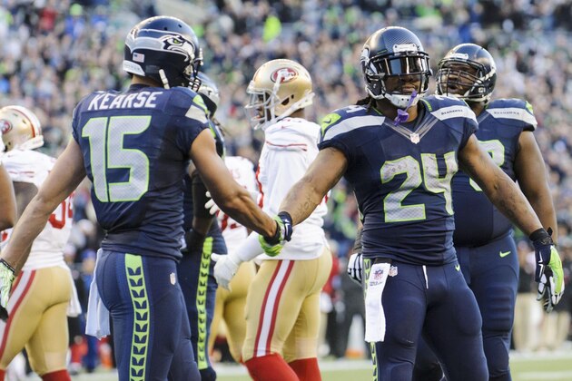 Dec 14, 2014; Seattle, WA, USA; Seattle Seahawks running back Marshawn Lynch (24) and Seattle Seahawks wide receiver Jermaine Kearse (15) shake hands after Lynch ran the ball in for a touchdown against the San Francisco 49ers during the second half at CenturyLink Field. Seattle defeated San Francisco 17-7. Mandatory Credit: Steven Bisig-USA TODAY Sports