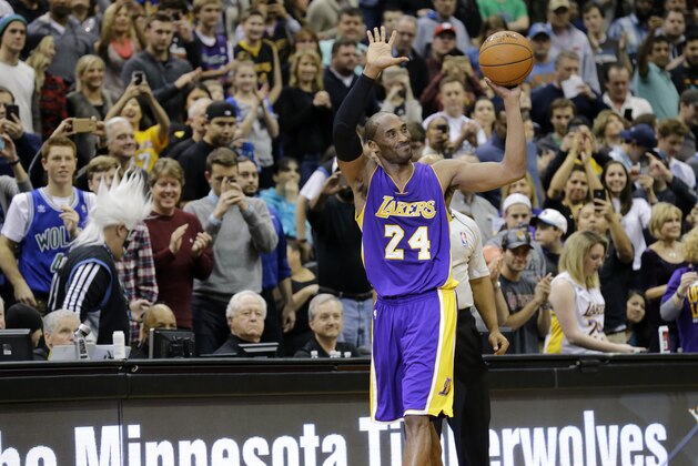 Los Angeles Lakers guard Kobe Bryant (24) holds up the game ball and acknowledges the crowd during the second quarter of an NBA basketball game against the Minnesota Timberwolves after passing Michael Jordan on the NBA all-time scoring list in Minneapolis, Sunday, Dec. 14, 2014. (AP Photo/Ann Heisenfelt)