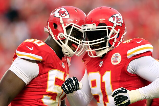 KANSAS CITY, MO - OCTOBER 20:  Outside linebacker Tamba Hali #91 of the Kansas City Chiefs is congratulated by outside linebacker Justin Houston #50 after sacking quarterback Case Keenum #7 of the Houston Texans late in the 2nd half of the game at Arrowhead Stadium on October 20, 2013 in Kansas City, Missouri.  (Photo by Jamie Squire/Getty Images)