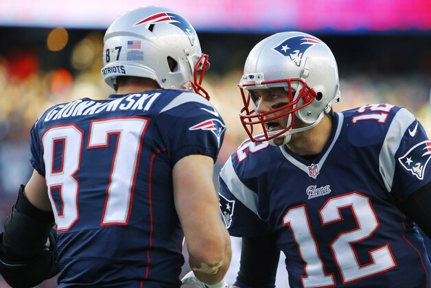 Dec 14, 2014; Foxborough, MA, USA; New England Patriots quarterback Tom Brady (12) celebrates with tight end Rob Gronkowski (87) after catching the ball to score a touchdown during the second half against the Miami Dolphins at Gillette Stadium. The Patriots won 41-13. Mandatory Credit: Winslow Townson-USA TODAY Sports