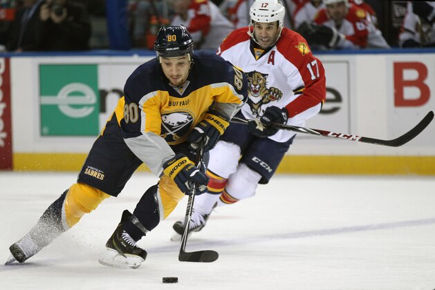 Buffalo Sabres right winger Chris Stewart (80) carries the puck as Florida Panthers center Derek Mackenzie (17) gives chase during the first period of an NHL hockey game Saturday, Dec. 13, 2014, in Buffalo, N.Y. (AP Photo/Gary Wiepert)