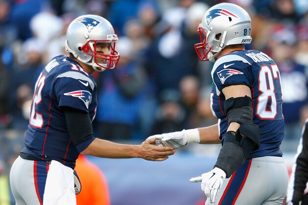 FOXBORO, MA - DECEMBER 14:  Tom Brady #12 and Rob Gronkowski #87 of the New England Patriots react after Gronkowski caught a touchdown pass during the third quarter against the Miami Dolphins at Gillette Stadium on December 14, 2014 in Foxboro, Massachusetts.  (Photo by Jim Rogash/Getty Images)