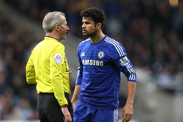 Chelsea's Diego Costa, right, argues with referee Martin Atkinson during their English Premier League soccer match against Newcastle United at St James' Park, Newcastle, England, Saturday, Dec. 6, 2014. (AP Photo/Scott Heppell)