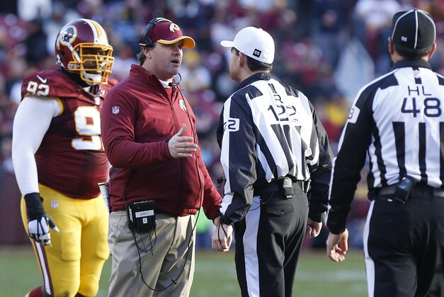 Dec 7, 2014; Landover, MD, USA; Washington Redskins head coach Jay Gruden (C) talks to referee Brad Allen (122) in the third quarter against the St. Louis Rams at FedEx Field. The Rams won 24-0. Mandatory Credit: Geoff Burke-USA TODAY Sports