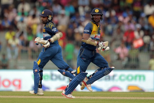 Sri Lankan batsmen Kumar Sangakkara, right, and Mahela Jayawardene run between wickets during their fourth one-day international cricket match with England in Colombo, Sri Lanka, Sunday, Dec. 7, 2014. (AP Photo/Eranga Jayawardena)