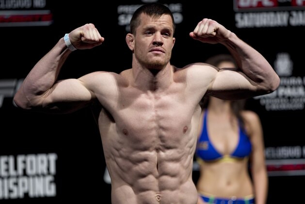 Fighter C.B. Dollaway from the US gestures as he weighs in ahead of the Ultimate Fighting Championship, UFC, in Sao Paulo, Brazil, Friday, Jan. 18, 2013. Dollaway will compete in the UFC in Sao Paulo on Jan. 19. (AP Photo/Andre Penner)