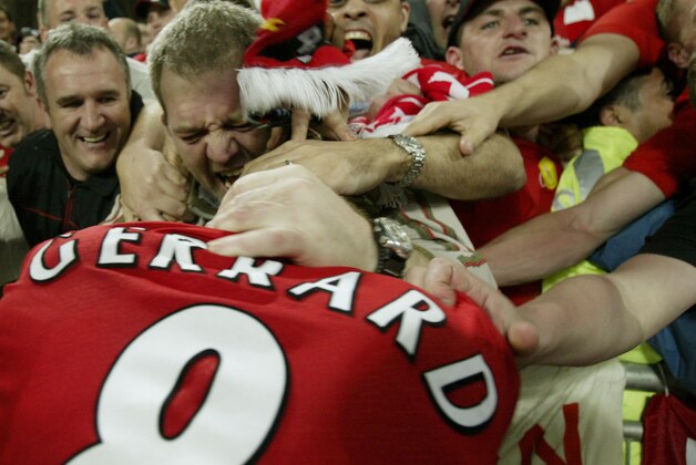 Liverpool's captain Steven Gerrard is embraced by fans after Liverpool's victory in the the UEFA Champions League Final between AC Milan and Liverpool at the Ataturk Olympic Stadium in  Istanbul, Turkey,Wednesday May 25, 2005. Liverpool won the match 3-2 on penalties.(AP Photo/Alastair Grant)