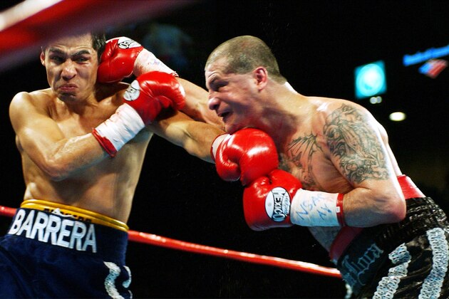 Johnny Tapia, right, and Marco Antonio Barrera trade blows in the ninth round of their lightweight bout   Saturday, Nov. 2, 2002, at the MGM Grand Hotel and Casino in Las Vegas. Barrera won by unanimous decision.(AP Photo/Laura Rauch)