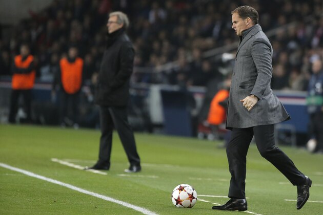 Ajax's head coach Frank de Boer, right, kicks the ball while PSG's head coach Laurent Blanc watches his team during the Champions League Group F soccer match between Paris Saint Germain and Ajax at Parc des Princes stadium in Paris, France, Tuesday, Nov. 25, 2014. (AP Photo/Francois Mori)