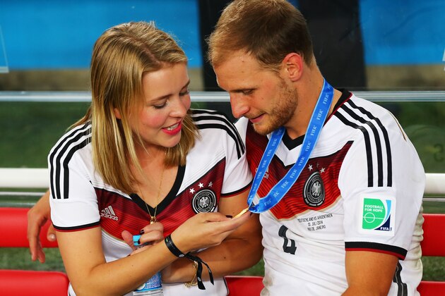 RIO DE JANEIRO, BRAZIL - JULY 13: Lisa Wesseler (L) looks at Benedikt Hoewedes of Germany's winners medal during the 2014 FIFA World Cup Brazil Final match between Germany and Argentina at Maracana on July 13, 2014 in Rio de Janeiro, Brazil.  (Photo by Martin Rose/Getty Images)