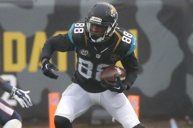 Jacksonville Jaguars wide receiver Allen Hurns (88) looks for room to run around Houston Texans cornerback Kareem Jackson (25) after a reception during the second half of an NFL football game in Jacksonville, Fla., Sunday, Dec. 7, 2014. (AP Photo/Stephen B. Morton)