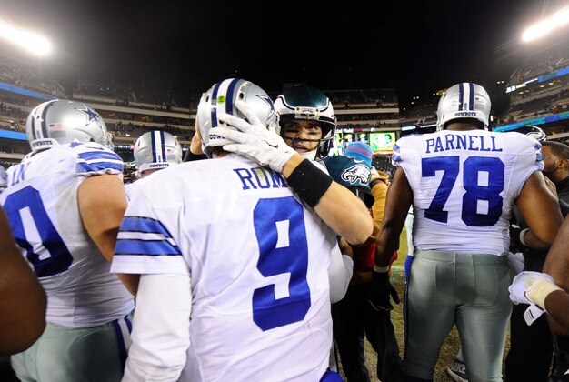 aDec 14, 2014; Philadelphia, PA, USA; Philadelphia Eagles quarterback Mark Sanchez (back) embraces Dallas Cowboys quarterback Tony Romo (9) after the Dallas Cowboys defeated the Philadelphia Eagles 38-27 at Lincoln Financial Field. Mandatory Credit: James Lang-USA TODAY Sports