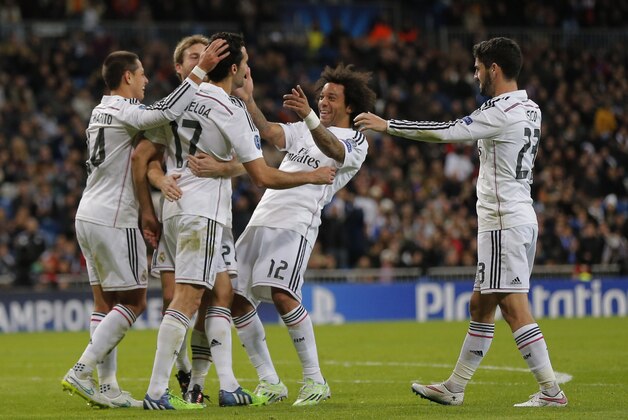 Real Madrid's Alvaro Arbeloa celebrates scoring his side's 3rd goal with teammates during a Group B Champions League soccer match between Real Madrid and Ludogorets at the Santiago Bernabeu stadium in Madrid, Spain, Tuesday Dec. 9, 2014. (AP Photo/Daniel Ochoa de Olza)