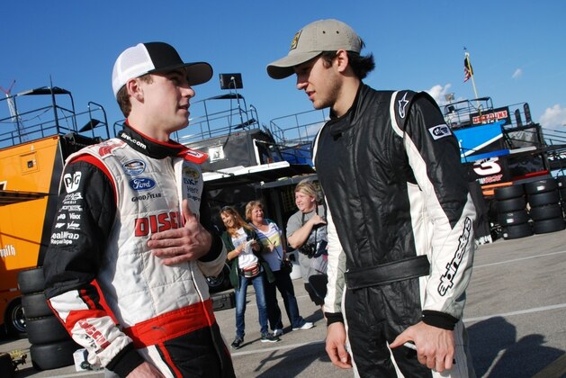 Ryan Blaney talks to Chase Elliott in the garage at Daytona International Speedway.