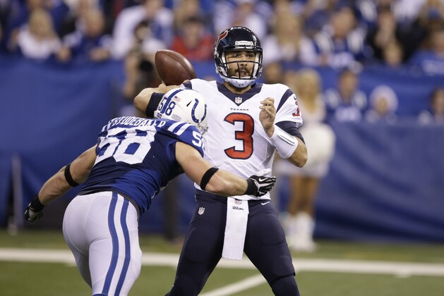 Houston Texans quarterback Tom Savage throws over Indianapolis Colts outside linebacker Andy Studebaker during the second half of an NFL football game in Indianapolis, Sunday, Dec. 14, 2014. (AP Photo/Darron Cummings)