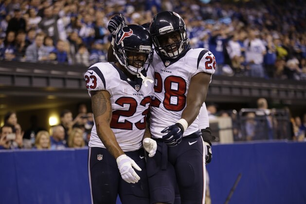 Houston Texans running back Arian Foster reacts with running back Alfred Blue after his touchdown runs was negated by a penalty during the second half of an NFL football game against the Indianapolis Colts in Indianapolis, Sunday, Dec. 14, 2014. (AP Photo/AJ Mast)