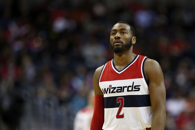 Washington Wizards guard John Wall (2) pauses on the court in the first half of an NBA basketball game against the Los Angeles Clippers, Friday, Dec. 12, 2014, in Washington. (AP Photo/Alex Brandon)