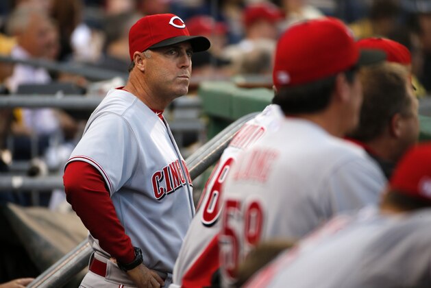 Cincinnati Reds manager Bryan Price stands in the dugout during the first inning of a baseball game against the Pittsburgh Pirates in Pittsburgh Monday, April 21, 2014. The Pirates won 6-5.  (AP Photo/Gene J. Puskar)