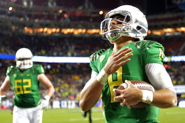 Dec 5, 2014; Santa Clara, CA, USA; Oregon Ducks quarterback Marcus Mariota (8) celebrates after scoring on a 7-yard touchdown run in the second quarter against the Arizona Wildcats in the Pac-12 Championship at Levi's Stadium. Mandatory Credit: Kirby Lee-USA TODAY Sports