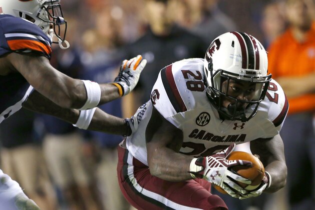 South Carolina's Mike Davis dives for a touchdown as Auburn defensive back Jonathon Mincy (6) tires to tackle him during the first half of an NCAA college football game on Saturday, Oct. 25, 2014, in Auburn, Ala. (AP Photo/Butch Dill)