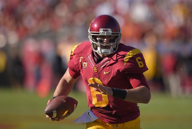 Southern California quarterback Cody Kessler runs with the ball during the first half an NCAA college football game against Notre Dame, Saturday, Nov. 29, 2014, in Los Angeles. Southern California won 49-14. (AP Photo/Mark J. Terrill)