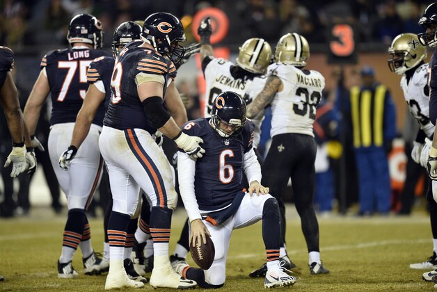 CHICAGO, IL - DECEMBER 15:  Ryan Groy #79 of the Chicago Bears helps teammate Jay Cutler #6 get up after he was sacked during the fourth quarter by John Jenkins #92 of the New Orleans Saints at Soldier Field on December 15, 2014 in Chicago, Illinois. The Saints defeated the Bears 31-15.  (Photo by Brian Kersey/Getty Images)