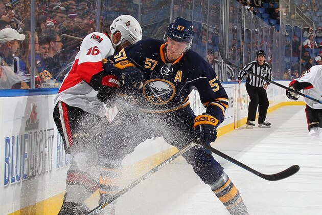 BUFFALO, NY - DECEMBER 15:Tyler Myers #57 of the Buffalo Sabres battles for the puck with Clarke MacArthur #16 of the Ottawa Senators on December 15, 2014 at the First Niagara Center in Buffalo, New York.  (Photo by Bill Wippert/NHLI via Getty Images)