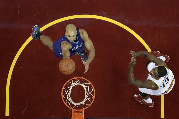 Charlotte Hornets' Gerald Henderson lays the ball in against Cleveland Cavaliers' Tristan Thompson (13) in the third quarter of an NBA basketball game Monday, Dec. 15, 2014, in Cleveland. (AP Photo/Mark Duncan)