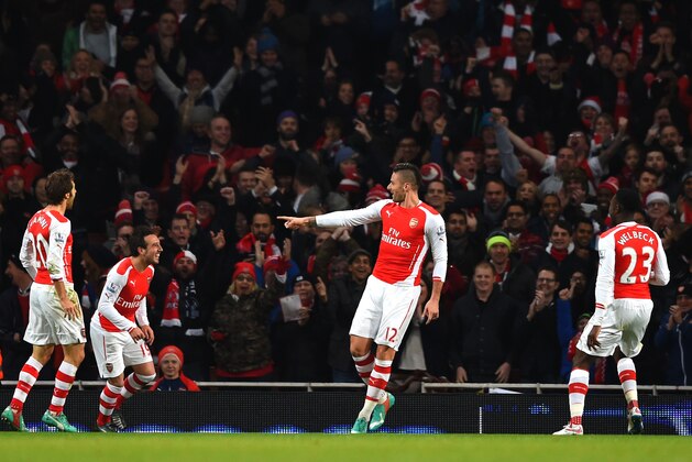 LONDON, ENGLAND - DECEMBER 13:  Olivier Giroud of Arsenal celebrates scoring the opening goal with team mates during the Barclays Premier League match between Arsenal and Newcastle United at Emirates Stadium on December 13, 2014 in London, England.  (Photo by Paul Gilham/Getty Images)