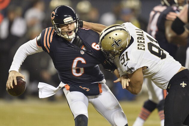 CHICAGO, IL - DECEMBER 15: Jay Cutler #6 of the Chicago Bears is pressured by Kasim Edebali #91 of the New Orleans Saints during the second quarter at Soldier Field on December 15, 2014 in Chicago, Illinois. (Photo by Brian Kersey/Getty Images)