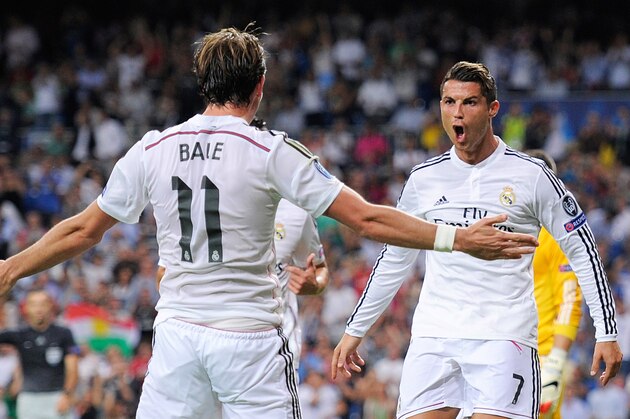 MADRID, SPAIN - SEPTEMBER 16:  Cristiano Ronaldo of Real Madrid celebrates with Gareth Bale after scoring Real's 3rd goal during the UEFA Champions League Group B match between Real Madrid CF and FC Basel 1893 on September 16, 2014 in Madrid, Spain.  (Photo by Denis Doyle/Getty Images)