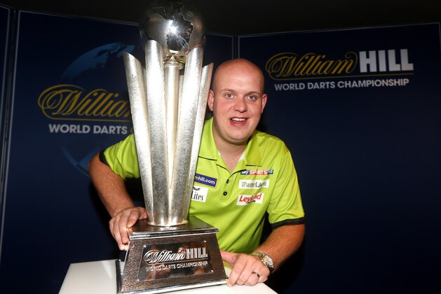 LONDON, ENGLAND - JUNE 13: Michael van Gerwen of Holland poses for a photo with the Sid Waddell trophy during William Hill World Darts Championship Sponsorship Launch at Rileys Sports Bar on June 13, 2014 in London, England. (Photo by Charlie Crowhurst/Getty Images)