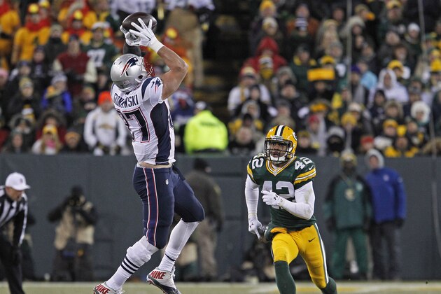 New England Patriots tight end Rob Gronkowski makes a catch while being covered by Green Bay Packers strong safety Morgan Burnett during an NFL football game Sunday Nov. 30, 2014, in Green Bay, Wis. (AP Photo/Matt Ludtke)