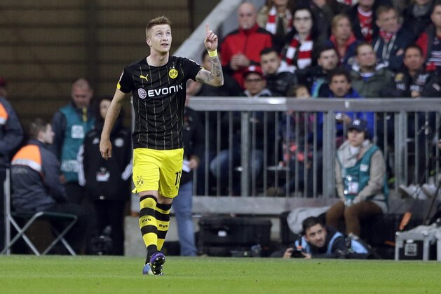 Dortmund's Marco Reus celebrates after scoring his side's opening goal during the German first division Bundesliga soccer match between FC Bayern and Borussia Dortmund in the Allianz Arena in Munich, Germany, Saturday, Nov. 1, 2014. (AP Photo/Matthias Schrader)
