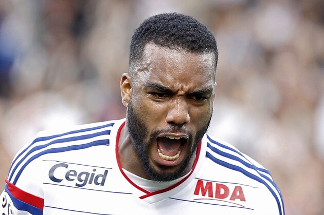 Lyon's Alexandre Lacazette celebrates after he scored his first goal against Lille during their French League One soccer match in Lyon, central France, Sunday, Oct. 5, 2014. (AP Photo/Laurent Cipriani)