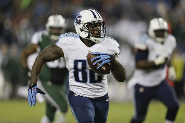 Tennessee Titans tight end Delanie Walker (82) carries the ball against the New York Jets  on the final play of the fourth quarter in an NFL football game Sunday, Dec. 14, 2014, in Nashville, Tenn. The ball was lateraled several times on the play but Walker was stopped at the 9-yard line. The Jets won 16-11.(AP Photo/James Kenney)