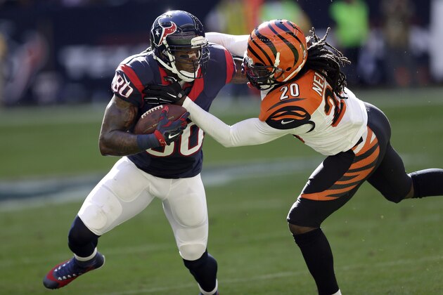 Houston Texans wide receiver Andre Johnson (80) catches a pass as Cincinnati Bengals free safety Reggie Nelson (20) defends during the second quarter of an NFL football game, Sunday, Nov. 23, 2014, in Houston. (AP Photo/David J. Phillip)