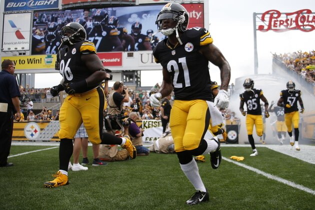 Pittsburgh Steelers safety Robert Golden (21) runs onto Heinz Field with teammates as they are introduction before the NFL football game against the Tampa Bay Buccaneers  on Sunday, Sept. 28, 2014 in Pittsburgh. (AP Photo/Gene Puskar)
