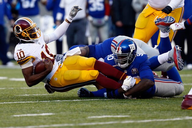 EAST RUTHERFORD, NJ - DECEMBER 14:   Robert Griffin III #10 of the Washington Redskins gets sacked by  Jason Pierre-Paul #90 of the New York Giants in the second half during their game at MetLife Stadium on December 14, 2014 in East Rutherford, New Jersey.  (Photo by Jeff Zelevansky/Getty Images)