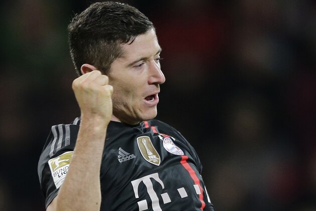 Bayern's Robert Lewandowski from Poland celebrates after scoring his side's third goal during the German first division Bundesliga soccer match between FC Augsburg and FC Bayern Munich in the SGL Arena in Augsburg, Germany, on Saturday, Dec. 13, 2014. (AP Photo/Matthias Schrader)