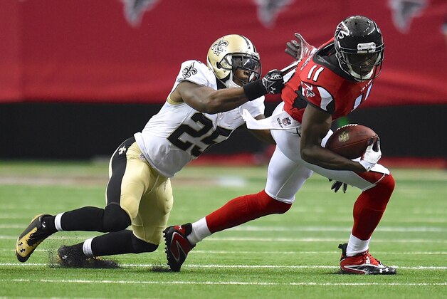 Sep 7, 2014; Atlanta, GA, USA; Atlanta Falcons wide receiver Julio Jones (11) tries to break a tackle by New Orleans Saints free safety Rafael Bush (25) during the second half at the Georgia Dome. The Falcons defeated the Saints 37-34 in overtime. Mandatory Credit: Dale Zanine-USA TODAY Sports
