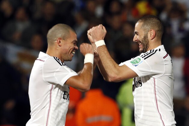 Real Madrid’s Karim Benzema, right, celebrates his goal with teammate Pepe during the semi final soccer match between Real Madrid and Cruz Azul at the Club World Cup soccer tournament in Marrakech, Morocco, Tuesday, Dec. 16, 2014. (AP Photo/Abdeljalil Bounhar)