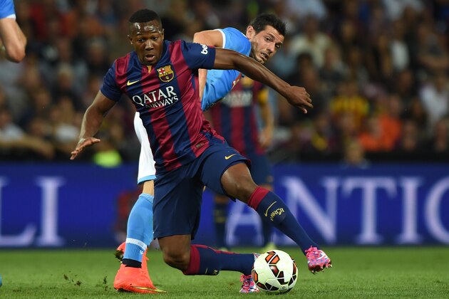 GENEVA, SWITZERLAND - AUGUST 06:  Adama Traore (L) of FC Barcelona is challenged by Blerim Dzemaili of SSC Napoli during the pre-season friendly match between FC Barcelona and SSC Napoli on August 6, 2014 in Geneva, Switzerland.  (Photo by Valerio Pennicino/Getty Images)